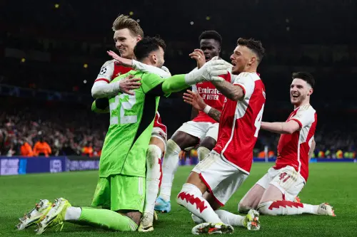 Arsenal players celebrate after winning the penalty shoot-out session the UEFA Champions League last 16 second leg football match between Arsenal and Porto FC at the Arsenal Stadium in north London. (Photo: AFP)