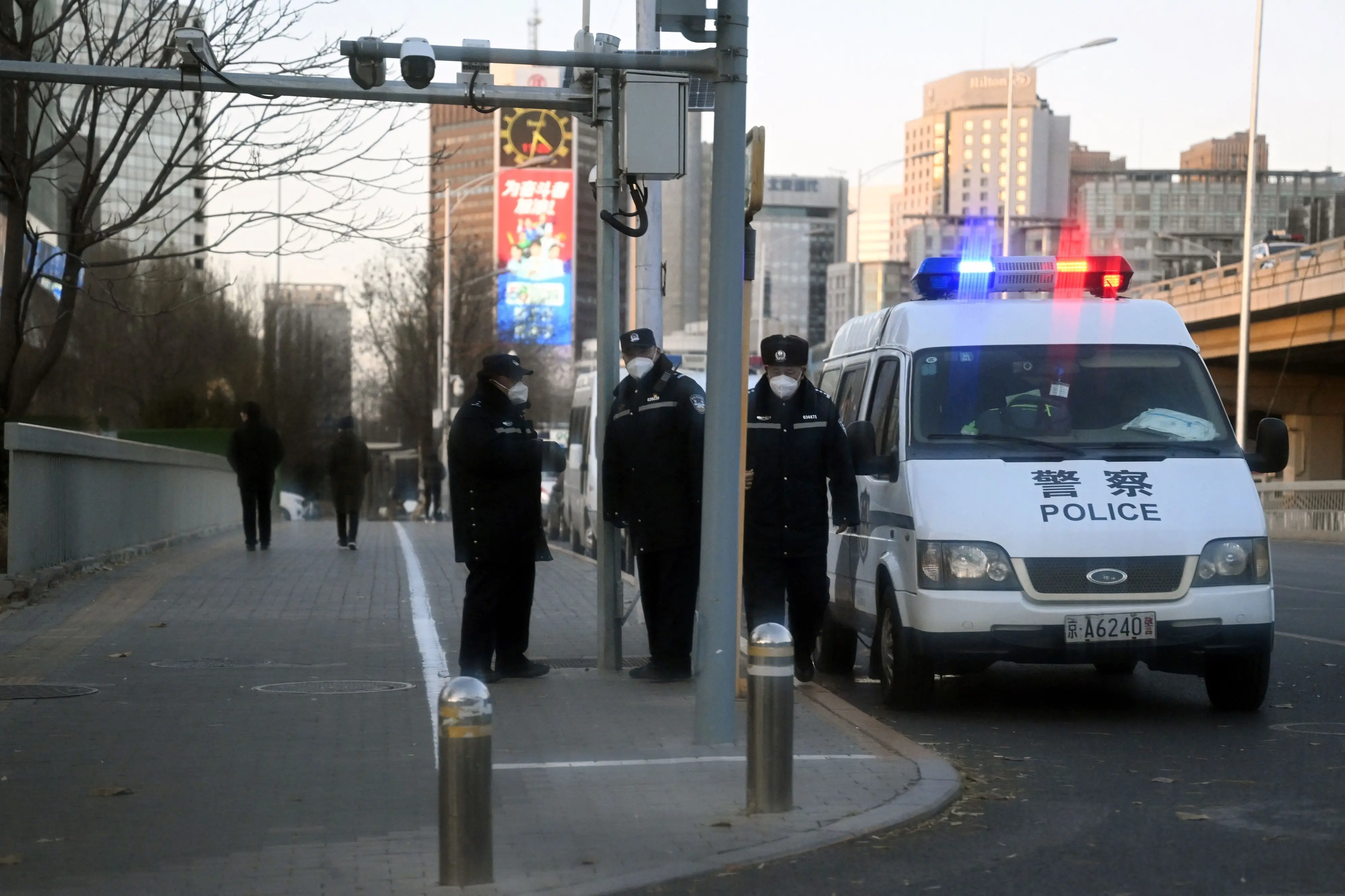 Police keep watch on a road by the Liangma River, where recent protests took place. Photo: AFP