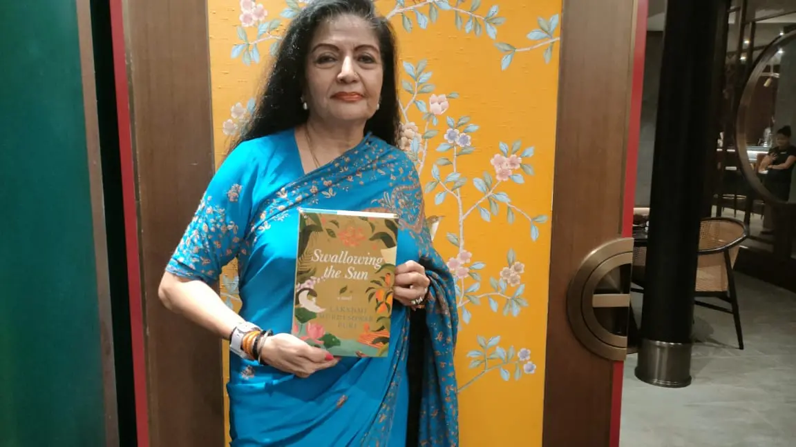 Lakshmi Puri seen with her book