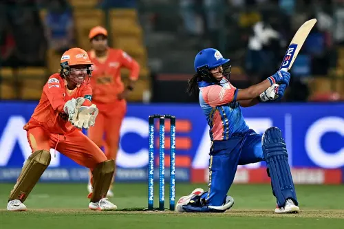 Harmanpreet Kaur of Mumbai Indians (R) plays a shot during the Women's Premier League (WPL) Twenty20 cricket match between Mumbai Indians and Gujarat Giants at the Chinnaswamy Stadium in Bengaluru. (Photo: AFP)