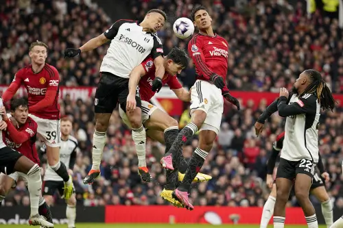Fulham's Rodrigo Muniz, centre left, Manchester United's Raphael Varane, centre right, and Manchester United's Harry Maguire, centre, challenge for the ball during the English Premier League soccer match between Manchester United and Fulham at Old Trafford stadium in Manchester. (Photo: AP)