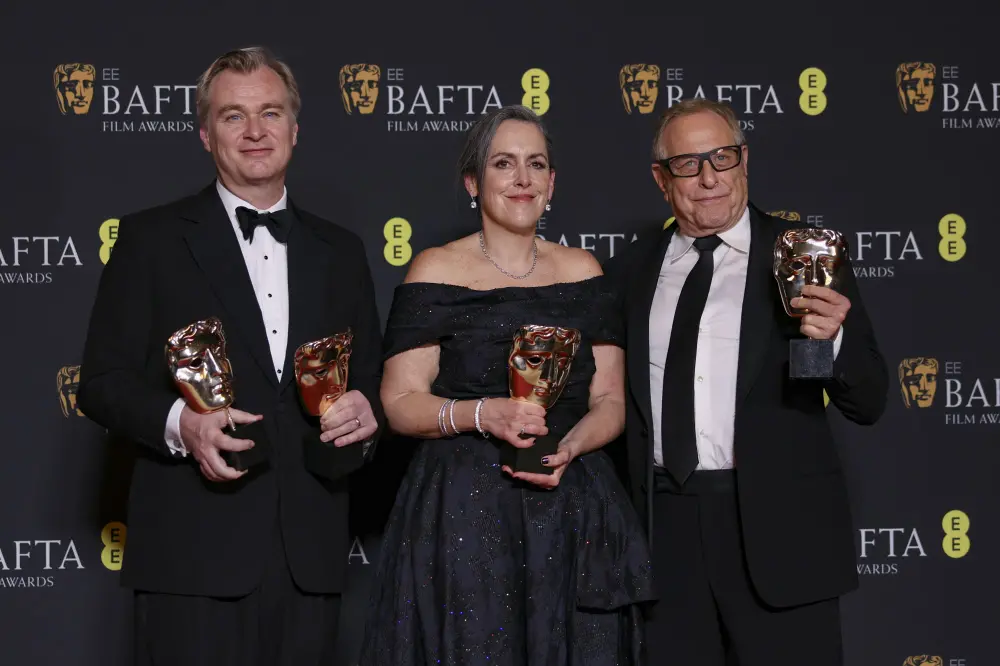 Director Christopher Nolan, from left, producer Emma Thomas, and producer Charles Roven, winners of the best film award for 'Oppenheimer', pose for photographers at the 77th British Academy Film Awards, BAFTA's, in London | AP