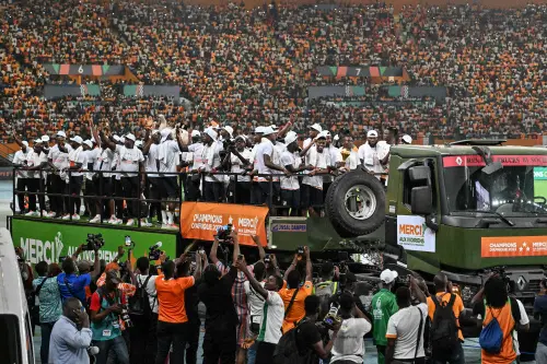 Ivory Coast players and their supervisors celebrate with the trophy at Abidjan's Felix Houphouet Boigny stadium at the end of the Africa Cup of Nations (CAN) 2024 victory parade on Monday. (Photo: AFP)