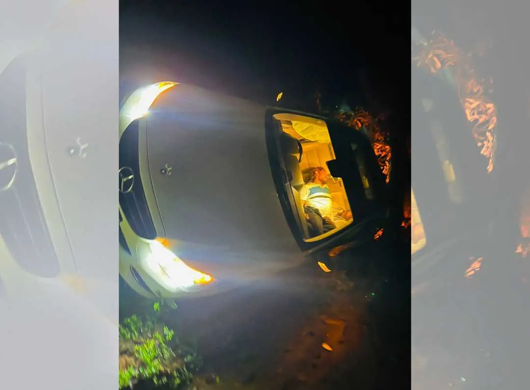 The car that met with the accident. One of the accused can be seen lying inside in an unconscious state.