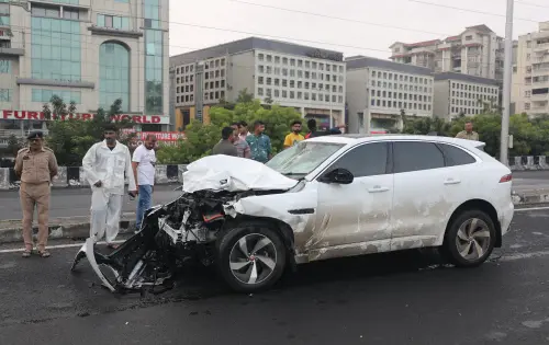 Ahmedabad: People stand near the wreckage of a vehicle after an accident in Ahmedabad,Thursday, July 20,2023. At least 9 dead, 13 injured in a major accident involving multiple vehicles at ISKCON flyover. (PTI Photo)