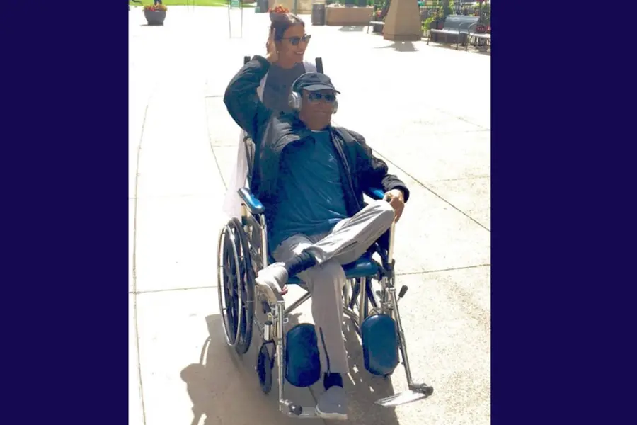 Rajinikanth is all smiles while being pushed around on a wheelechair by daughter