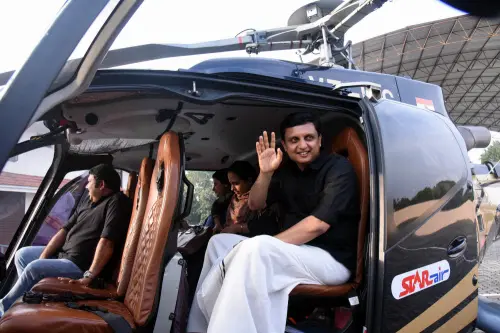 Kochi: Kerala Tourism Minister PA Mohammed Riyas with the passengers in a helicopter after inaugurating the heli-tourism operation, at the Nedumbassery Cochin International Airport Limited (CIAL) Academy Grounds, in Kochi, Saturday, Dec. 30, 2023. (PTI Photo)