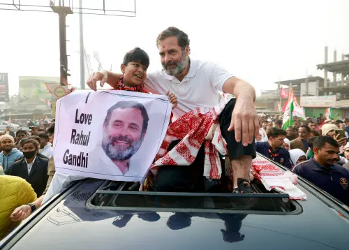A child holds a poster of Congress leader Rahul Gandhi as he sits with him during the party's Bharat Jodo Nyay Yatra. (Photo: ANI)