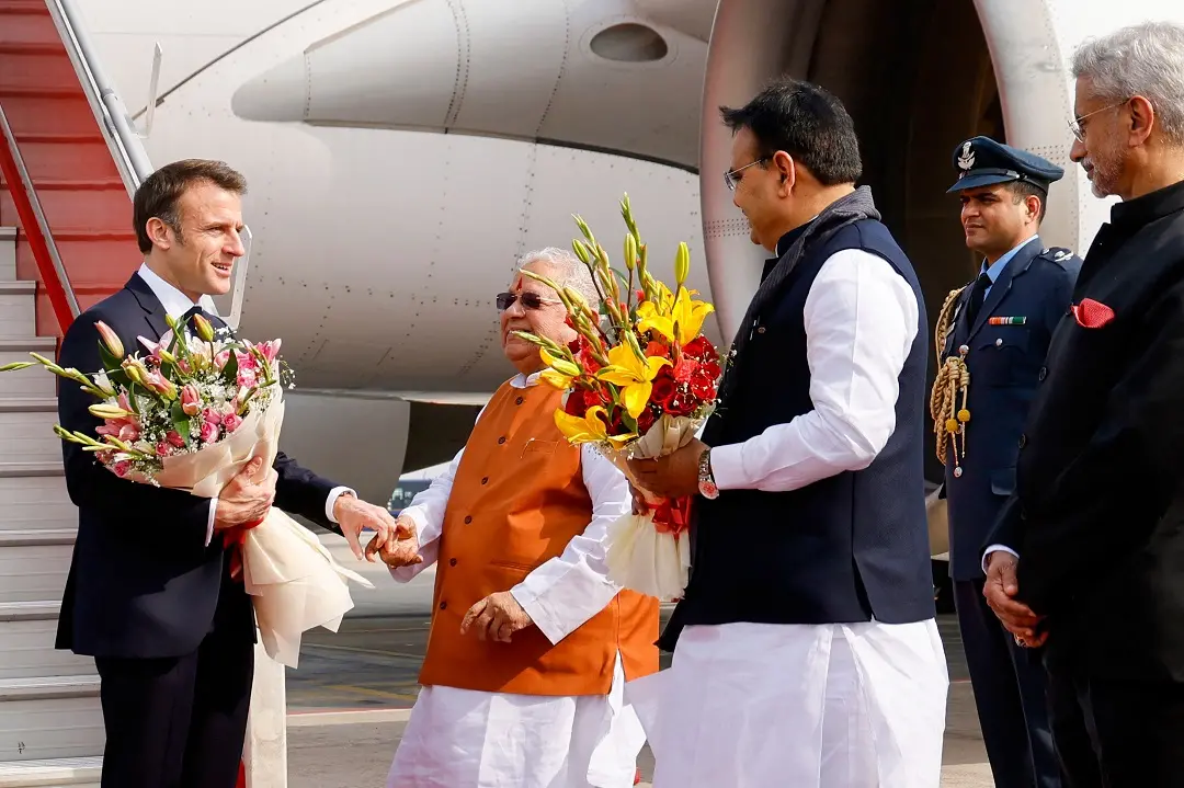 France's President Emmanuel Macron (L) arrives at Jaipur International Airport on January 25, 2024. President Emmanuel Macron arrives as the guest of honour in India on January 25, 2024, with a sumptuous palace feast and colourful military parade, as France eyes lucrative deals with the world's fifth-biggest economy | Photo:AFP