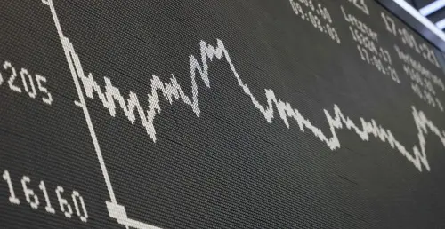 A display shows the German Stock Market Index DAX at the stock exchange in Frankfurt, Germany | Photo: AFP