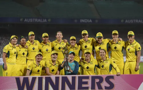 Australian players pose with the trophy after winning the T20 series against India Women, at DY Patil Stadium in Navi Mumbai on Tuesday. (Photo: PTI)