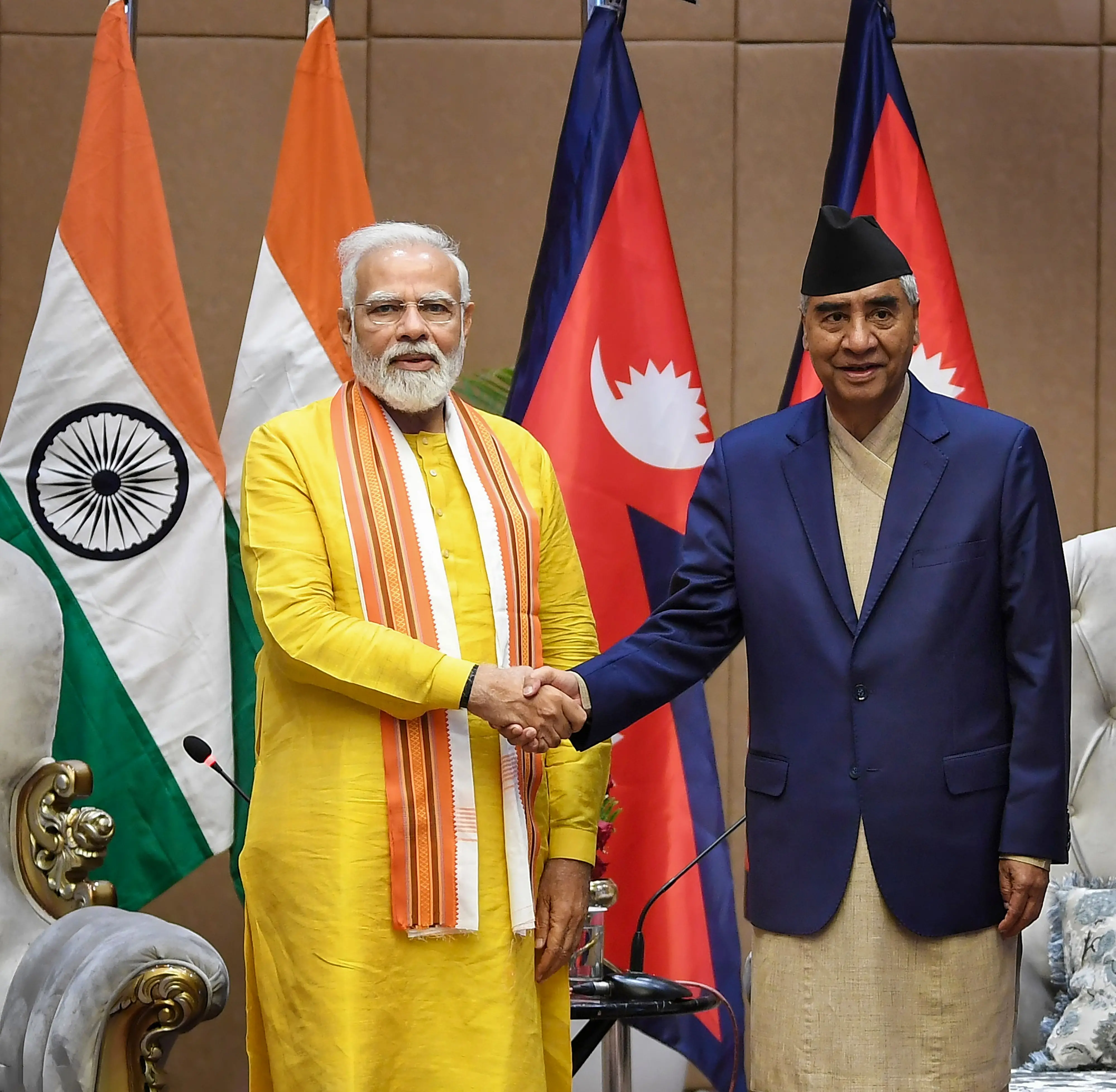 PM Modi meets Nepal PM Sher Bahadur Deuba. Photo: PTI