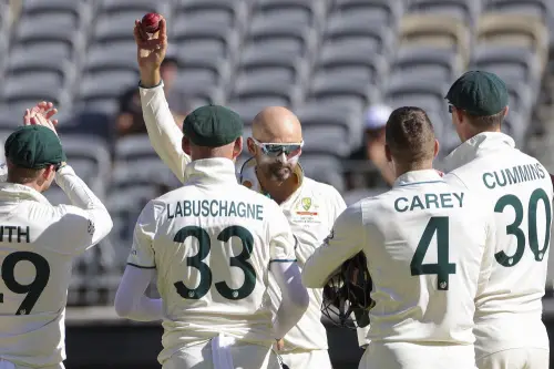 Australia's Nathan Lyon, center, holds the ball aloft after dismissing Pakistan's Faheem Ashraf to claim his 500th test match wicket during play on the fourth day of the first cricket test between Australia and Pakistan in Perth, Australia, Sunday, Dec. 17, 2023. Australia defeated Pakistan by 360 runs. AP/PTI