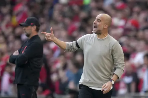 Pep Guardiola(R) gestures next to Liverpool's manager Jurgen Klopp I AP