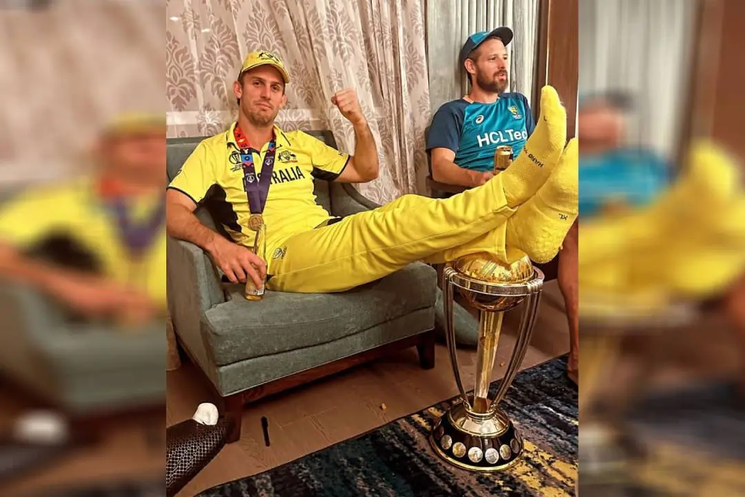 Mitchell Marsh resting his feet on the World Cup trophy