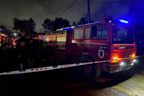 View of a fire brigade truck parked near the site where a fire tore through a housing settlement killing 14 Venezuelan migrants| AFP