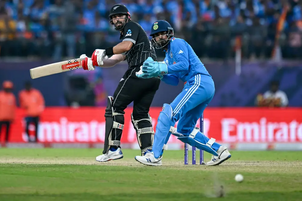 Daryl Mitchell (L) plays a shot | AFP