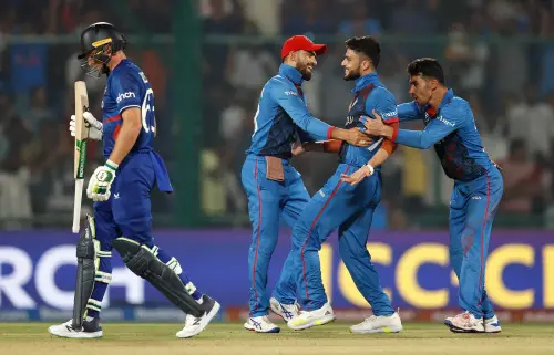 New Delhi, Oct 15 (ANI): Afghanistan's Naveen-ul-Haq and teammates celebrate the dismissal of England's Captain Jos Buttler during their match in the ICC Cricket World Cup 2023, at Arun Jaitley Stadium in New Delhi on Sunday. (ANI Photo)