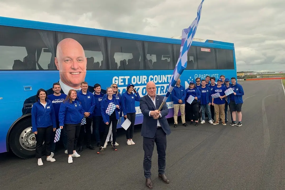 National Party leader Christopher Luxon waves a flag in front of supporters and a campaign bus in Rotorua, New Zealand | File photo: AP