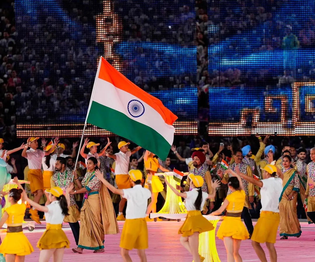 Flag-bearers Lovlina Borgohain and Harmanpreet Singh lead the Indian contingent during the opening ceremony of the 19th Asian Games at the Hangzhou Olympic Sports | Photo: PTI