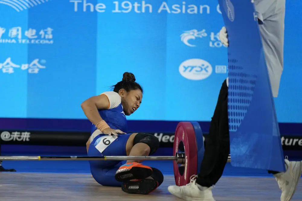 Mirabai Chanu Saikhom reacts in pain after she got injured during the competition | PTI