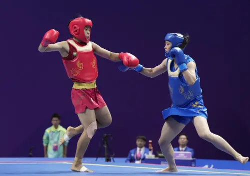 Hangzhou: India's Naorem Roshibina Devi (L) fights against China's Xiaowei Wu in the finals of the Women's 60 kg Wushu event at the 19th Asian Games, in Hangzhou, China, Thursday, Sept. 27, 2023. (PTI Photo/Gurinder Osan)