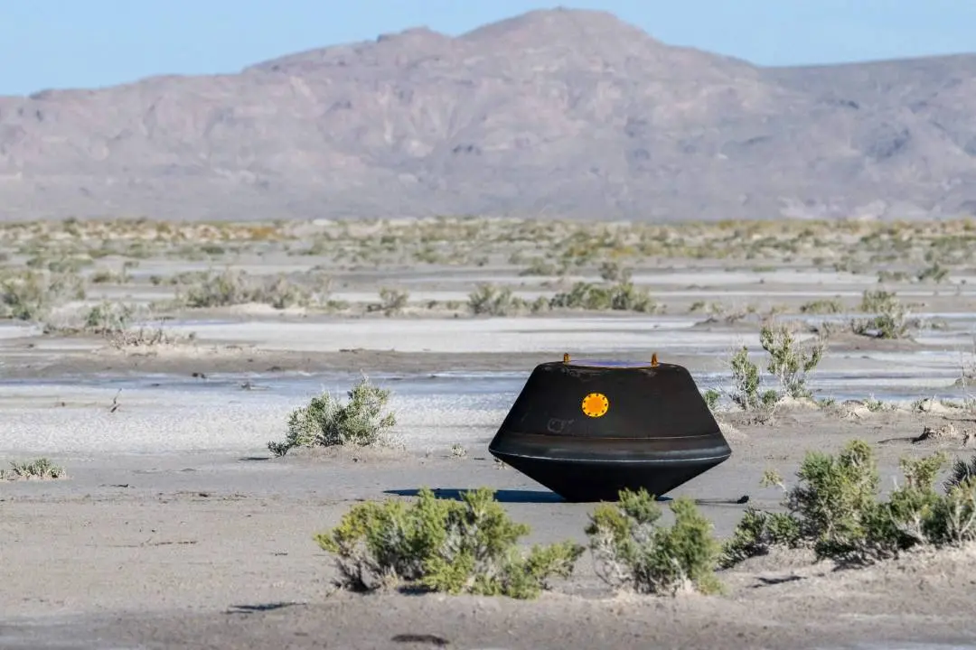 The sample return capsule from NASA's OSIRIS-REx mission is seen shortly after touching down in the desert, Sunday, September 24, 2023 | AFP
