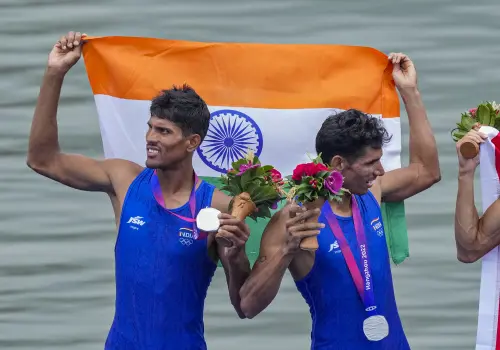 Hangzhou: India's Arjun Lal Jat and Arvind Singh wave Indian tricolours as they stand at the podium after winning silver medal in Men's Light-weight Double Sculls at the 19th Asian Games, in Hangzhou, China, Sunday, Sept. 24, 2023. (PTI Photo/Gurinder Osan)