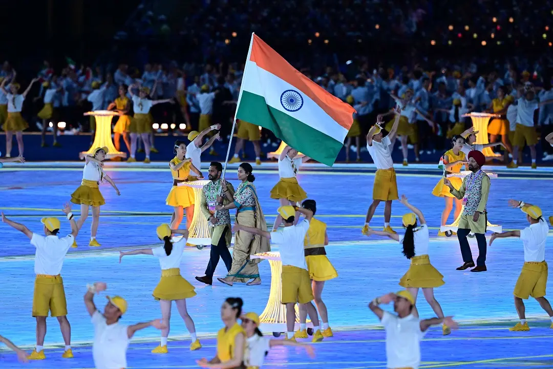Members of India's delegation take part in the athletes parade during the opening ceremony of the 2022 Asian Games at the Hangzhou Olympic Sports Centre Stadium in Hangzhou in China's eastern Zhejiang province | Photo: AFP