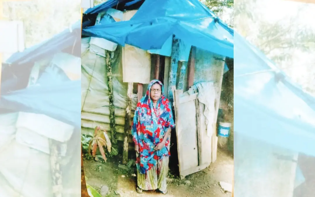 Aamina in front of her makeshift tent.
