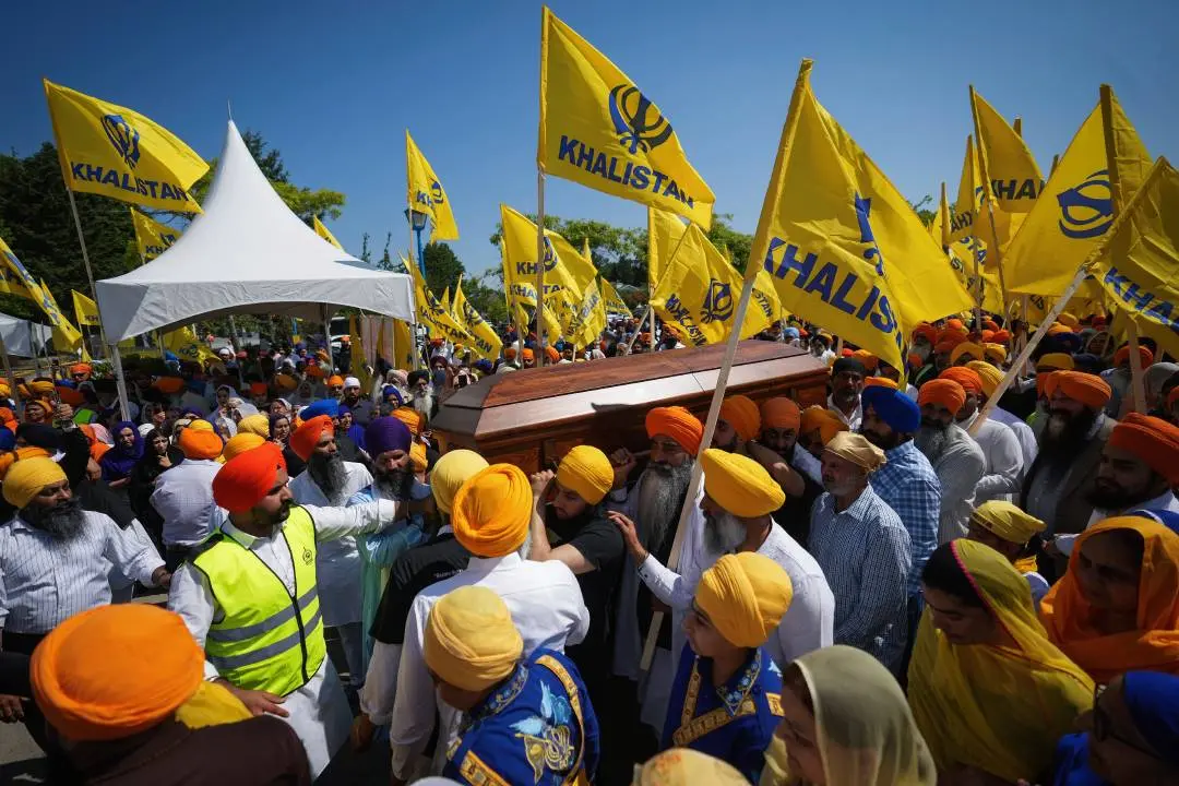 Mourners carry the casket of Sikh community leader and temple president Hardeep Singh Nijjar in Surrey, British Columbia, Sunday, June 25, 2023.