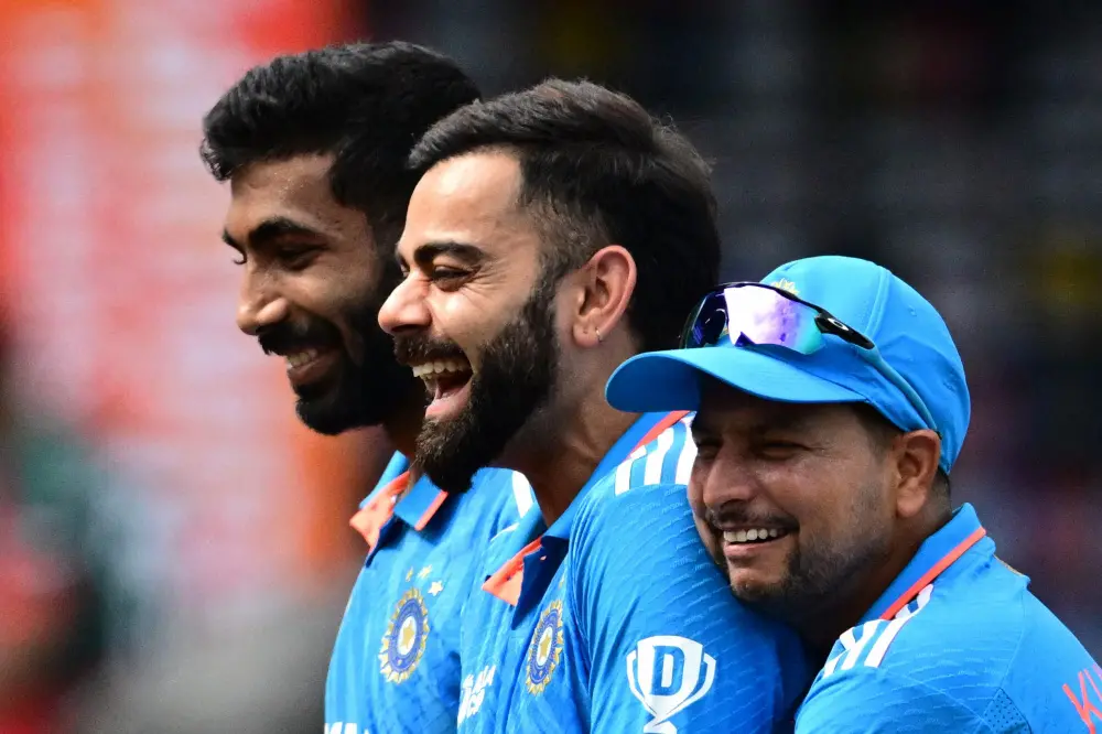 Virat Kohli (C), Jasprit Bumrah (L) and Kuldeep Yadav | AFP