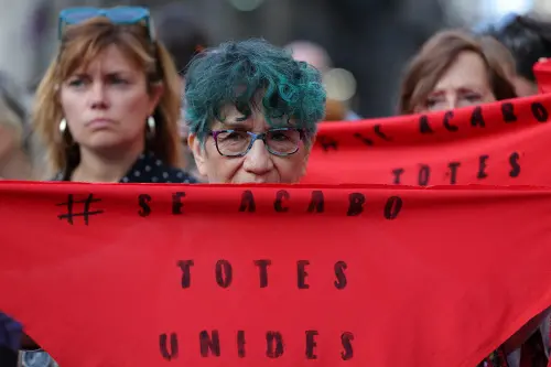 Demonstrators hold red kerchieves reading 'It's over. Everyone united' as they take part in a protest in support of football player Jenni Hermoso in Barcelona on September 4, 2023. Spain's men football team rejected today the 'unacceptable behavior' of the suspended president of the Spanish football federation, Luis Rubiales, with his forced kiss on the player Jenni Hermoso. (Photo by LLUIS GENE / AFP)