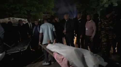 This videograb shows a body being brought to hospital in Antananarivo on August 25, 2023 following a stampede at a stadium. At least 13 people, including seven children, were killed Friday in a crowd stampede at a stadium in the Madagascar capital of Antananarivo, according to the Red Cross and a local member of parliament. (Photo by Chris DELMAS / AFP)