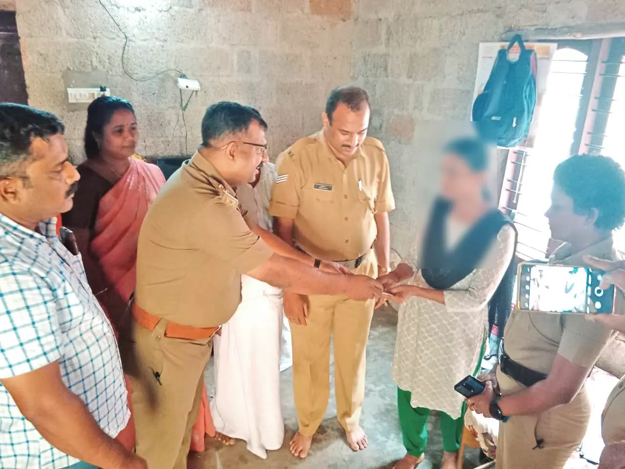 Excise officials hand over help to Biju's family.