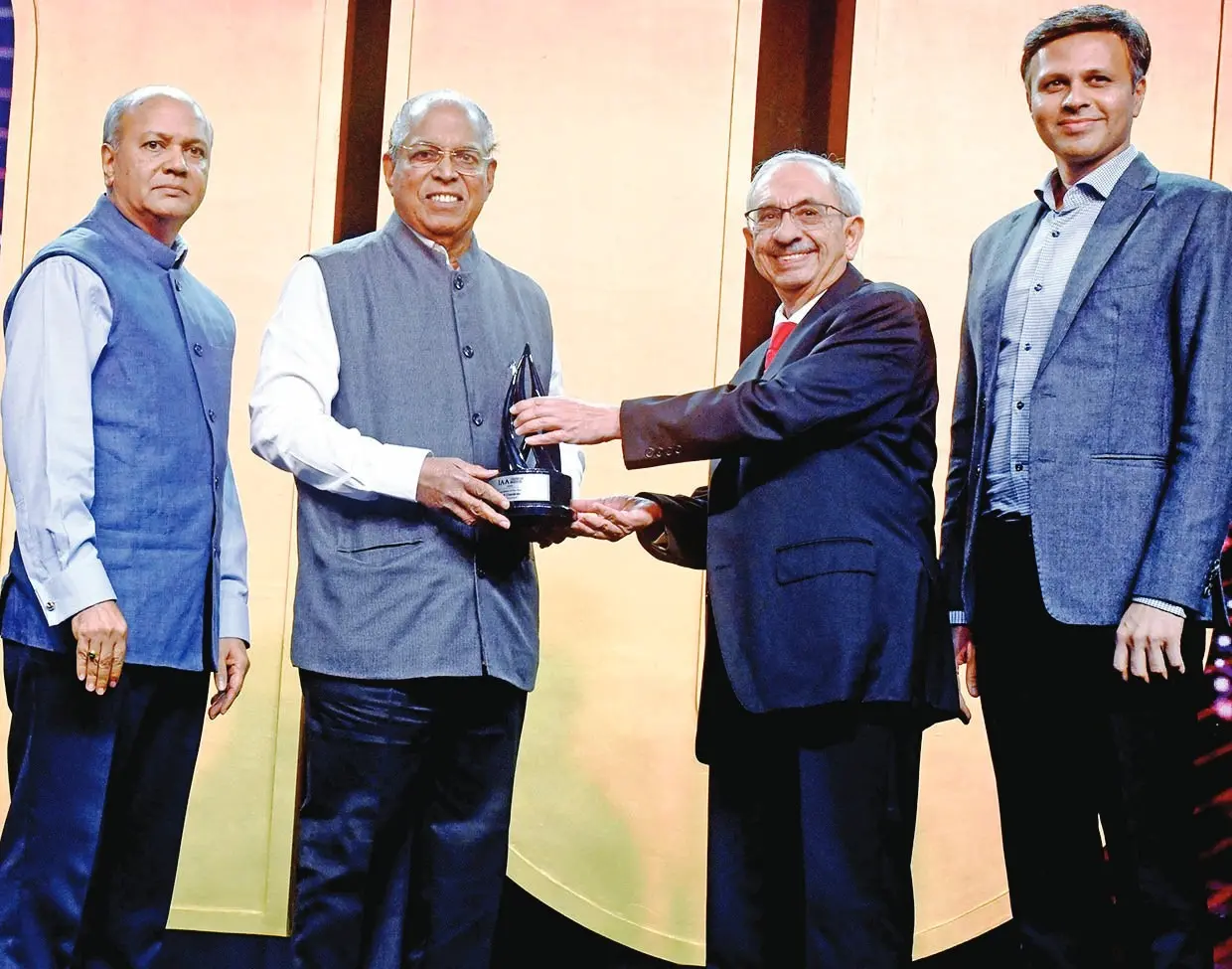 PV Chandran receiving IAA's award from Nadir B. Godrej in the presence of Ramesh Narayan, Founder of Canco Advertising Pvt Limited and Abhishek Karnani, Chairman of Free Press Journal