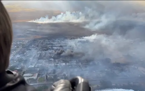 This handout video grab courtesy of Richard Olsten taken on August 9, 2023 shows smoke billowing from destroyed buildings as wildfires burn across Maui. Desperate residents jumped into the ocean in a bid to escape the fast-moving flames. Photo: AFP