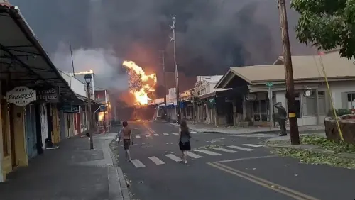People watch as smoke and flames fill the air from raging wildfires on Front Street in downtown Lahaina, Maui on Tuesday, Aug. 8, 2023. Maui officials say wildfire in the historic town has burned parts of one of the most popular tourist areas in Hawaii. County of Maui spokesperson Mahina Martin said in a phone interview early Wednesday fire was widespread in Lahaina, including Front Street, an area of the town popular with tourists | Photo: AP