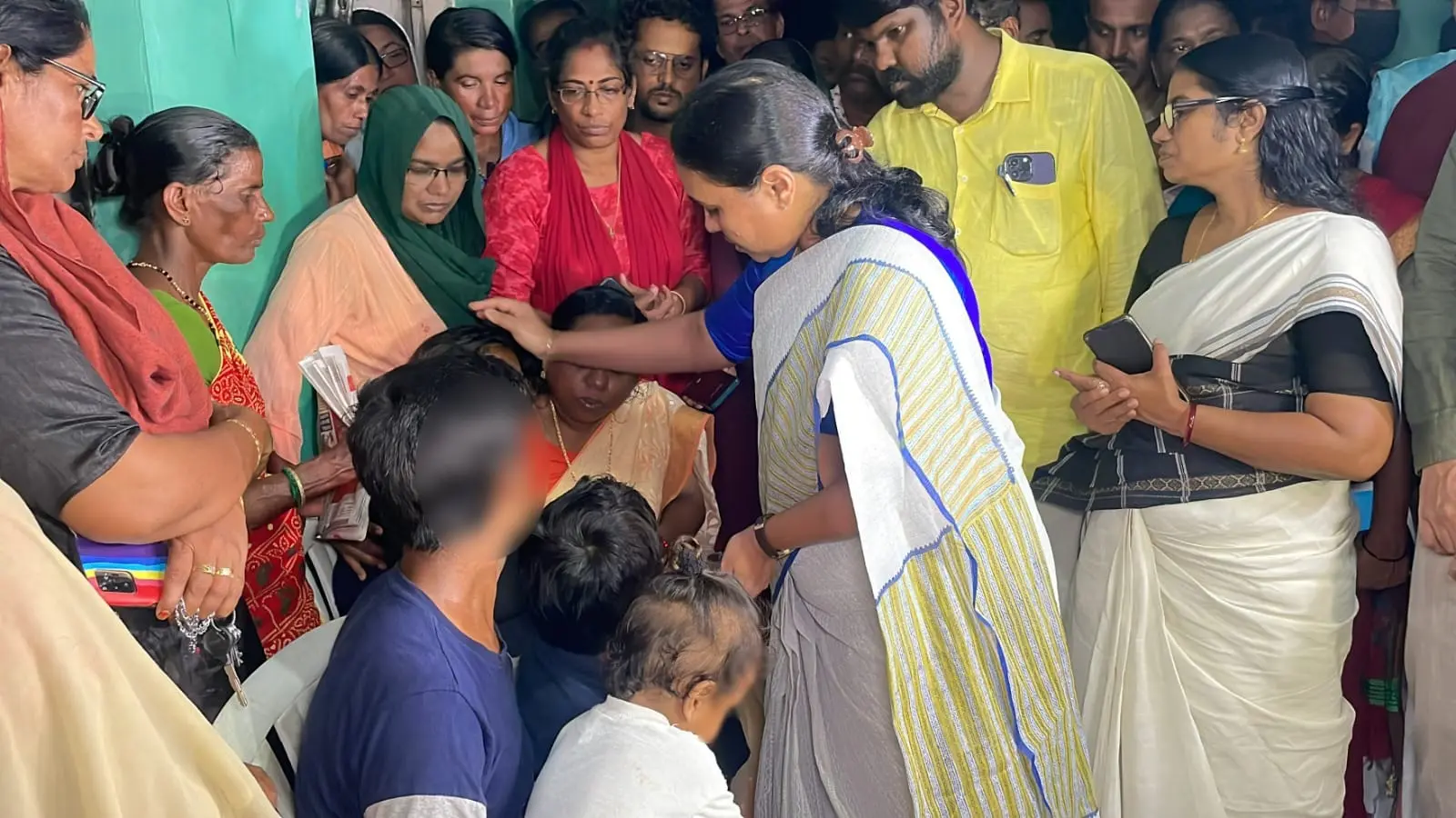 Minister Veena George consoling deceased's family | Photo Courtesy: https://www.facebook.com/veenageorgeofficial