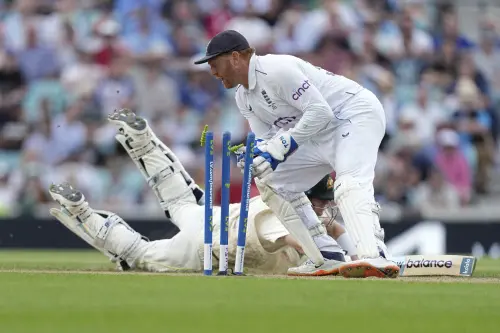 England's wicketkeeper Jonny Bairstow, right, breaks the stumps in an attempt to dismiss Australia's Steven Smith, on ground, during the second day of the fifth Ashes Test match between England and Australia at The Oval cricket ground in London, Friday, July 28, 2023. (AP Photo/Kirsty Wigglesworth)
