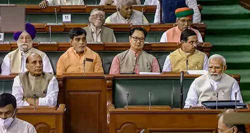 Prime Minister Narendra Modi with Union Ministers Rajnath Singh, Kiren Rijiju, Hardeep Singh Puri and other MPs in the Lok Sabha | Photo: PTI