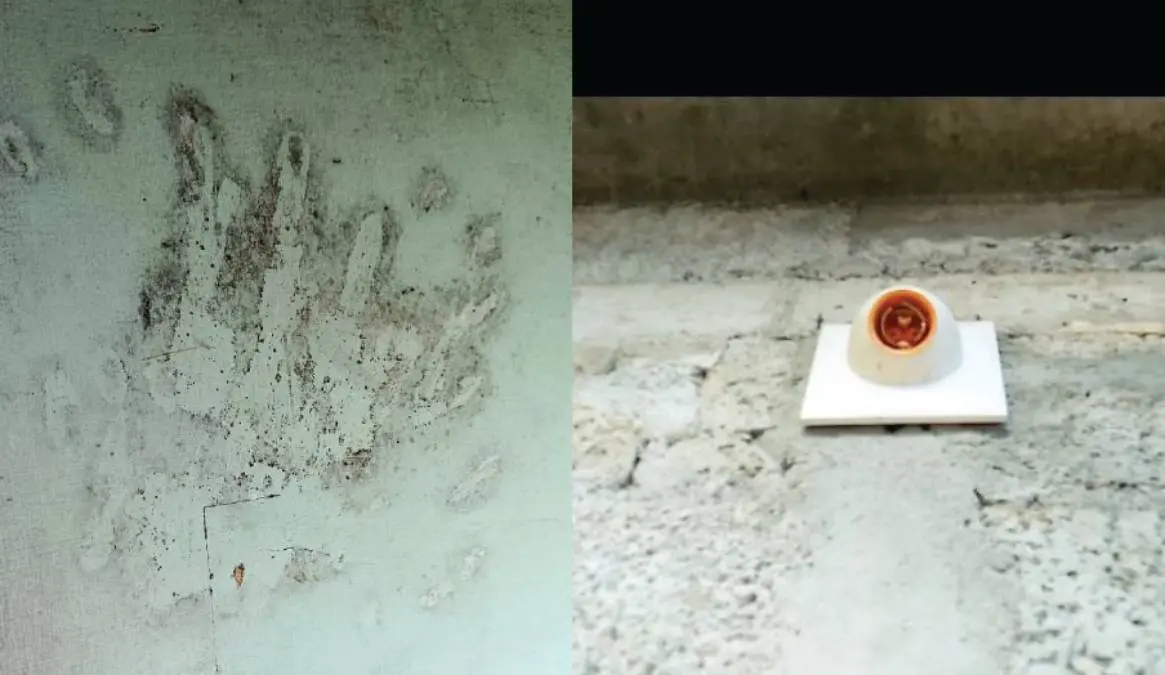 Oil smeared hand print on a wall, missing bulb