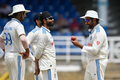 Rohit Sharma (R), Ravindra Jadeja (2L) and Ravichandran Ashwin (L) of India inspect the ball during the third day of the second Test cricket match between India and West Indies at Queen's Park Oval in Port of Spain, Trinidad and Tobago, July 22, 2023. (Photo by Randy Brooks / AFP)