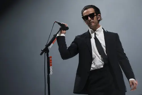 FILE - Matty Healy of the 1975 performs at the Reading Music Festival, England, Sunday, Aug. 28, 2022. Malaysia's government has cut short a music festival after the lead singer of British band The 1975 slammed the country's anti-gay laws and kissed a male bandmate during their performance. Malaysia's communications and digital minister has slammed Matty Healy's conduct late Friday, July 21, 2023 at the start of the Good Vibes Festival as "very rude." (Photo by Scott Garfitt/Invision/AP, file)