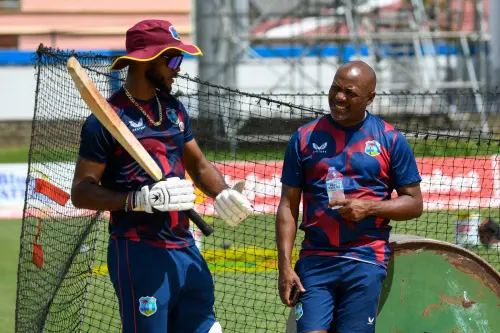 Kraigg Brathwaite (L) and Brian Lara (R), of West Indies, speak during practice at Queens Park Oval in Port of Spain, Trinidad and Tobago, on July 19, 2023, one day before the start of their 2nd test match against India. (Photo by Randy Brooks / AFP)