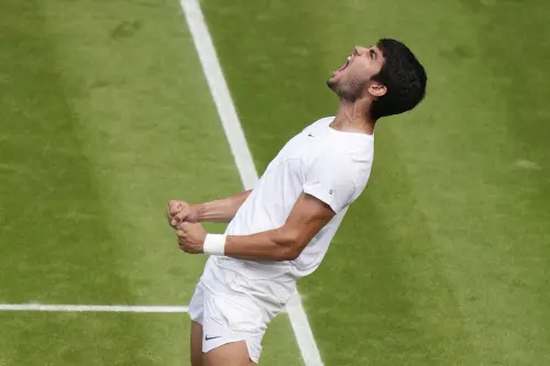 Spain's Carlos Alcaraz celebrates after beating Denmark's Holger Rune to win their men's singles match on day ten of the Wimbledon tennis championships in London, Wednesday, July 12, 2023. (AP Photo/Alberto Pezzali)
