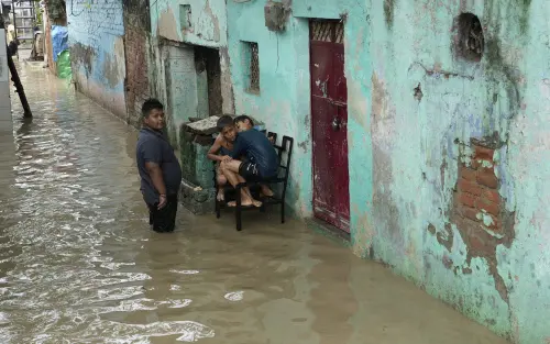 Locals wade through a flooded bylane at Yamuna Bazar area, in New Delhi, Tuesday, July 11, 2023 | Photo: PTI