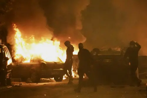 Youths clash with police forces as cars burn in Nanterre, outside Paris, Thursday, June 29, 2023. French President Emmanuel Macron has described the killing of a 17-year-old delivery driver by police at a traffic check 'inexcusable,' and called for a thorough investigation. The death in the Paris suburb of Nanterre prompted scattered violence overnight. (AP Photo/Christophe Ena)