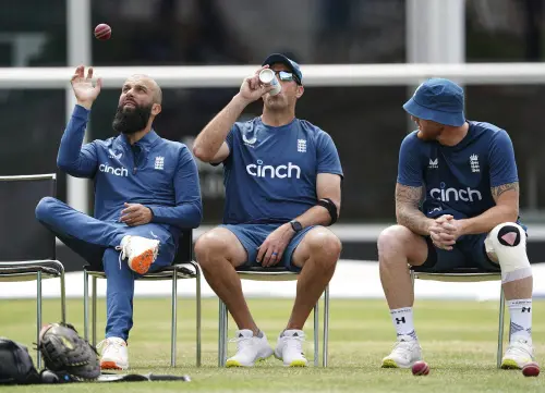 England's Moeen Ali, batting coach Marcus Trescothick, and Ben Stokes sit during a nets session at Lord's Cricket Ground, London, Monday June 26, 2023, ahead of the second Ashes Test cricket match on Wednesday. (Mike Egerton/PA via AP)