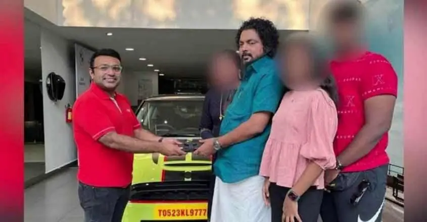 Anil Kumar receiving the key of his latest car at the showroom.